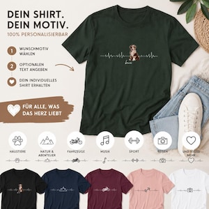 May include: Dark green t-shirt with a dog illustration and a heartbeat line design. The shirt has the text "Bowie" under the dog. Other shirts with different designs are shown below, including a mountain, motorcycle, music note, and camera.