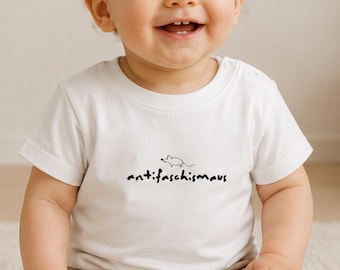 May include: A white short-sleeved baby t-shirt with a round neckline and two snap buttons on the shoulder. The center of the chest features a small black line drawing of a mouse above the black text that reads antifaschismaus.