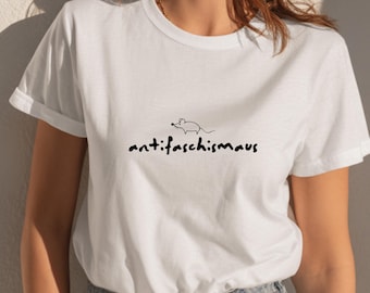May include: White t-shirt with a black graphic of a mouse and the word "antifaschismaus" in a handwritten font. The shirt has short sleeves and a crew neck.