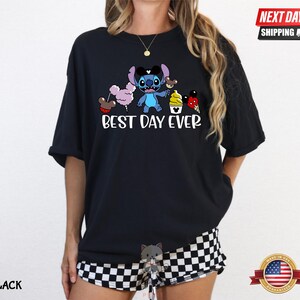 A person wearing a black t-shirt with a cartoon character and text printed on it.