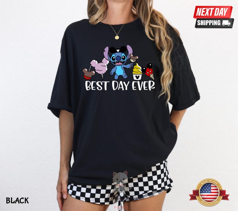 A person wearing a black t-shirt with a cartoon character and text printed on it.
