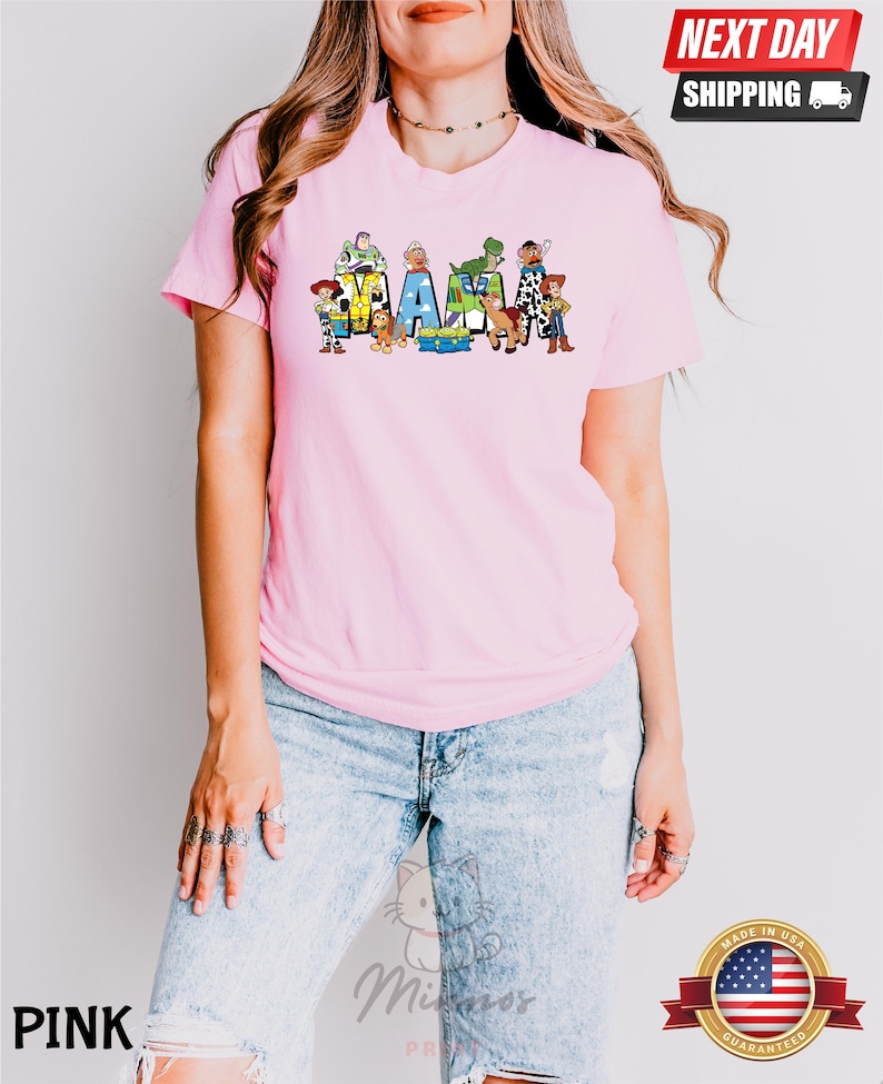 May include: Pink t-shirt with a graphic of Toy Story characters spelling out "MAMA".