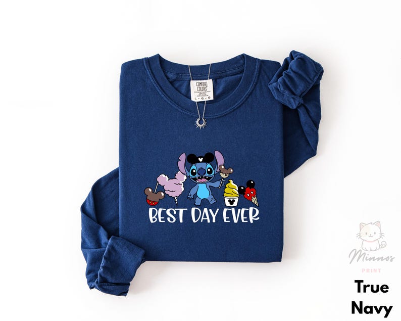 A navy blue long-sleeved t-shirt with a cartoon character and text printed on it.