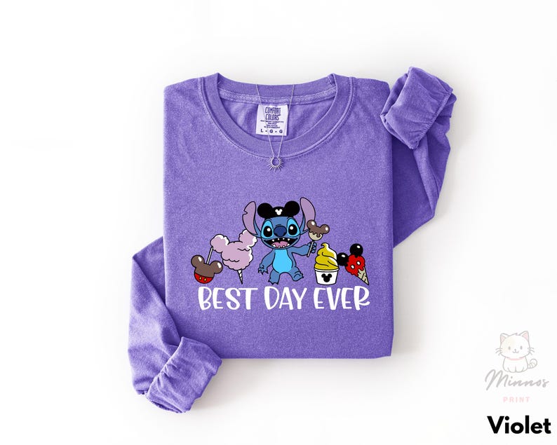 A purple long-sleeved t-shirt with a cartoon character and text printed on it.