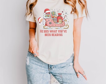 Book Lover Christmas Shirt, Santa Reading Tee, Funny Bookish Xmas Top, He Sees What You’ve Been Reading Shirt, Holiday Reader Graphic Tee