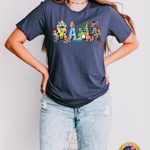 May include: A heather navy blue t-shirt with a graphic of Toy Story characters spelling out "MAMA".
