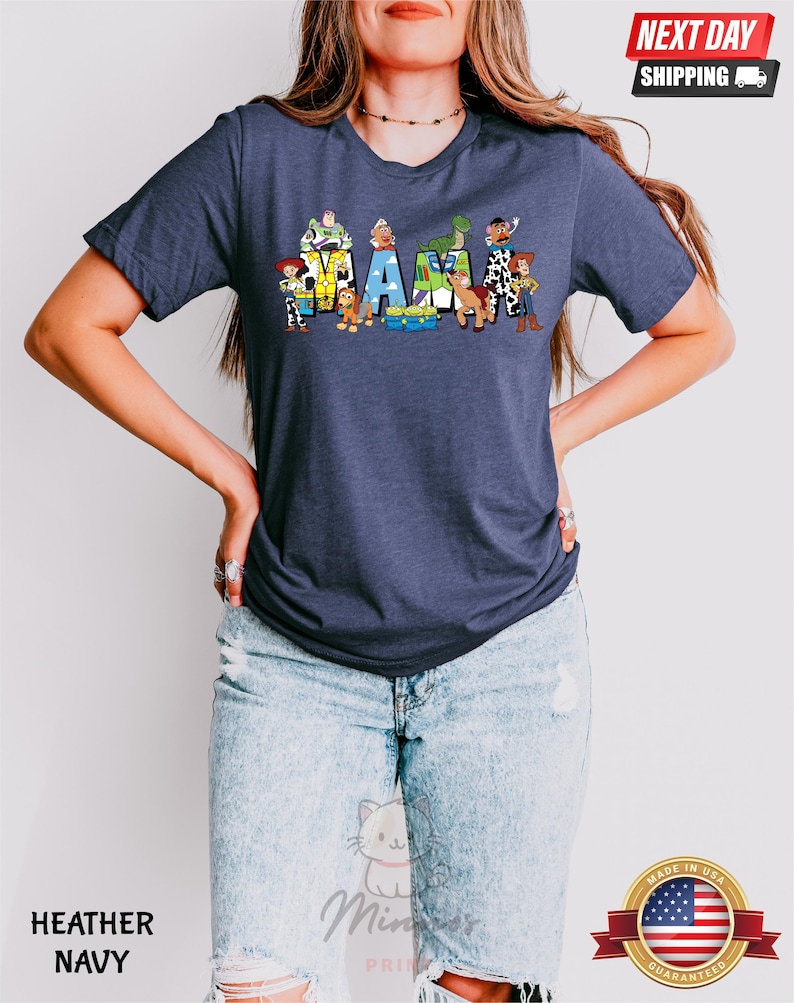 May include: A heather navy blue t-shirt with a graphic of Toy Story characters spelling out "MAMA".