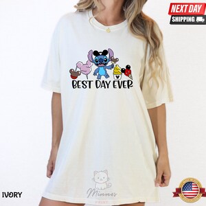 A white t-shirt with a graphic design featuring a cartoon character and the text "Best Day Ever".