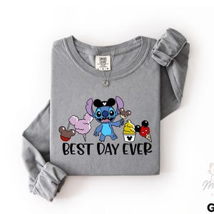 A gray long-sleeved t-shirt with a cartoon character and text printed on it.