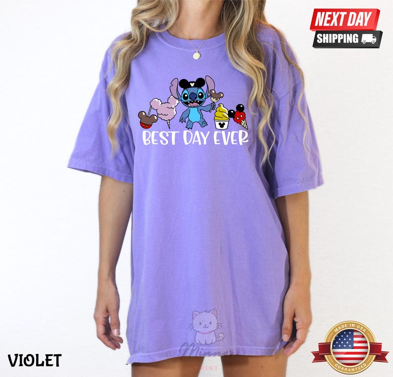 A person wearing a purple t-shirt with a cartoon character and text printed on it.