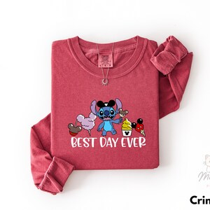 A red long-sleeved t-shirt with a cartoon character and text printed on it.