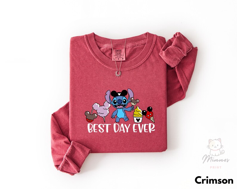 A red long-sleeved t-shirt with a cartoon character and text printed on it.