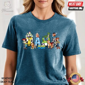 May include: A blue t-shirt with a graphic of the Toy Story characters spelling out "MAMA".