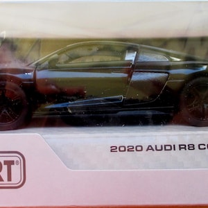 May include: A black 2020 Audi R8 Coupé model car in a clear plastic display case. The car has black wheels and a spoiler. The packaging includes the "Kinsmart" logo and a warning about choking hazards.