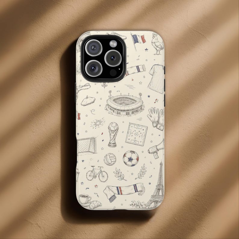 May include: A phone case with a cream background and a repeating pattern of French-themed illustrations in black and white. The design includes a soccer ball, Eiffel Tower, and a beret.