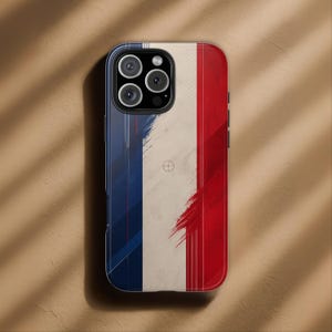 May include: A phone case featuring the French flag design. The case has a blue, white, and red color scheme with a brushstroke effect. The phone case has a black border and a camera cutout.