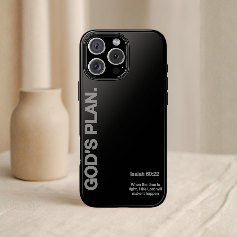 May include: Black phone case with the text "GOD'S PLAN." and the Bible verse Isaiah 60:22. The case has a glossy finish and features a camera module with three lenses.