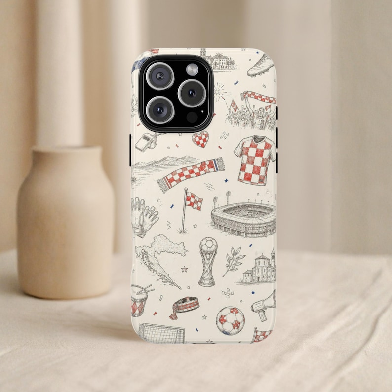 May include: A phone case with a cream background and a repeating pattern of Croatian soccer-themed illustrations in black and red. The design includes a soccer ball, stadium, jersey, and flag.