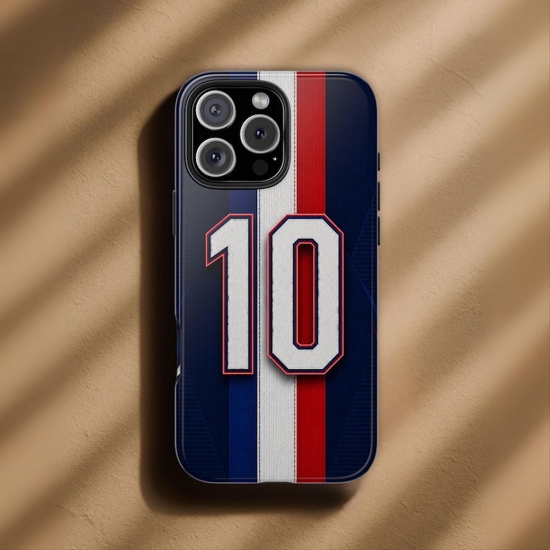 May include: A navy blue phone case with a vertical white, red, and white stripe design. The number "10" is prominently displayed in white with a red outline. The case has a glossy finish and a camera cutout.