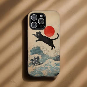 May include: A smartphone case featuring a graphic illustration of a black cat leaping over stylized blue ocean waves. A large, solid red circle is positioned in the upper right area against a light beige background, framing the cat in mid-air.