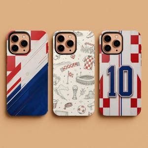 May include: Three phone cases with Croatian-themed designs. One case features a red and white checkered pattern with blue accents. The second case has a doodle-style design with soccer-related illustrations. The third case displays a soccer jersey with the number 10.