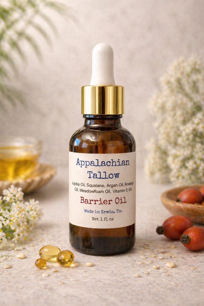 May include: A brown glass bottle of Appalachian Tallow Barrier Oil with a gold cap and white dropper. The label lists ingredients like Jojoba Oil and Vitamin E. The bottle is 1 fl oz.