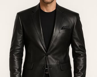 May include: A black leather blazer with a notched lapel, single-button closure, and two front pockets. The blazer has a pocket square and is paired with black pants and a black shirt. A watch is visible on the wrist.