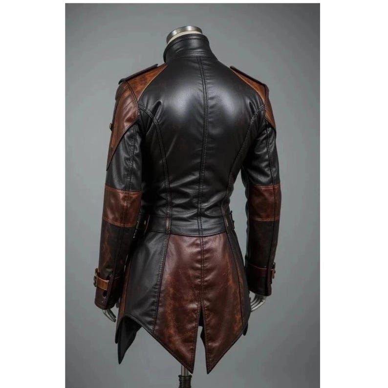 May include: A two-tone leather jacket in black and brown, displayed on a mannequin. The jacket features a high collar, shoulder epaulets, and a tailored fit with a flared bottom. Details include buckle accents and a unique panel design.