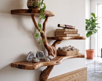 May include: A unique, wooden tree-shaped wall shelf with three tiers. The shelves hold a potted plant, books, a telescope, and decorative stones. The natural wood grain and organic design create a rustic, artistic display.