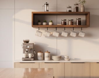 May include: A modern kitchen setup featuring a wooden shelf with coffee-related items. Includes a coffee maker, mugs, jars of coffee beans, and small potted plants. The color scheme is neutral with wood and white tones.