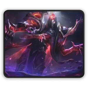 May include: Rectangular mousepad featuring a digital art illustration of a fantasy character with a long, dark cloak and a mask. The character has red and purple skin, with a cosmic background. The mousepad has a black border.