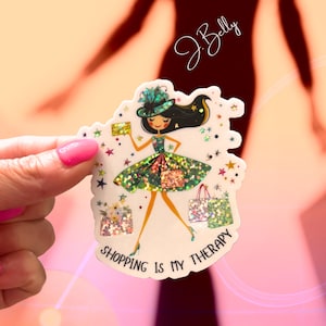 May include: A sticker featuring a cartoon woman in a green dress and hat, holding a gold card and shopping bags. The sticker has a glittery effect and the text "SHOPPING IS MY THERAPY".