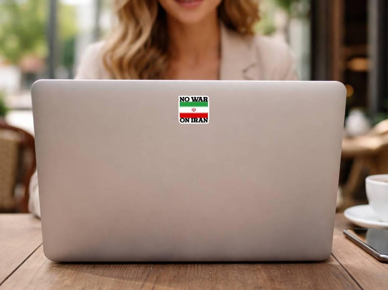 No War On Iran political peace sticker applied to laptop, waterproof vinyl protest decal