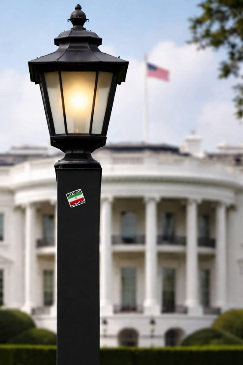 No War On Iran vinyl decal applied to black lamp post with White House in background, anti war political protest sticker