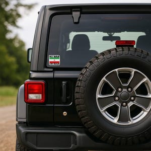 No War On Iran protest sticker displayed on Jeep rear window, anti war car decal for activism