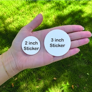 May include: Two circular white stickers with black text. The smaller sticker is labelled 2 inch Sticker and the larger sticker is labelled 3 inch Sticker. Both stickers are round and feature a clean, plain white background with bold black lettering.