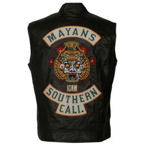 May include: Black leather vest featuring the "Mayans M.C." logo on the back. The logo includes a detailed emblem with a skull and the text "Southern Cali."