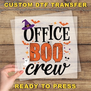 May include: A Halloween-themed DTF transfer with the words "OFFICE BOO CREW" in black and orange. The design includes a witch hat, bats, a spider, a ghost, and stars. The text "CUSTOM DTF TRANSFER" and "READY TO PRESS" are also present.