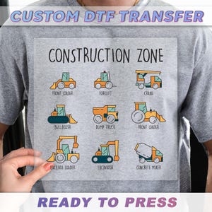 a person holding up a construction zone t - shirt