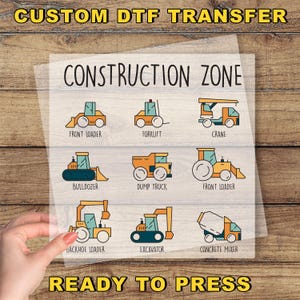 a hand holding a construction zone sticker on a piece of paper