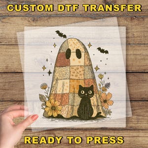 May include: A DTF transfer featuring a patchwork ghost with a black cat, bats, and floral accents. The text "CUSTOM DTF TRANSFER" and "READY TO PRESS" are displayed in yellow. The design is on a transparent sheet.