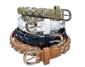 May include: A stack of braided belts in various colors: olive green, white, black, and brown. Each belt features a gold-colored buckle. The belts are made of a woven material.