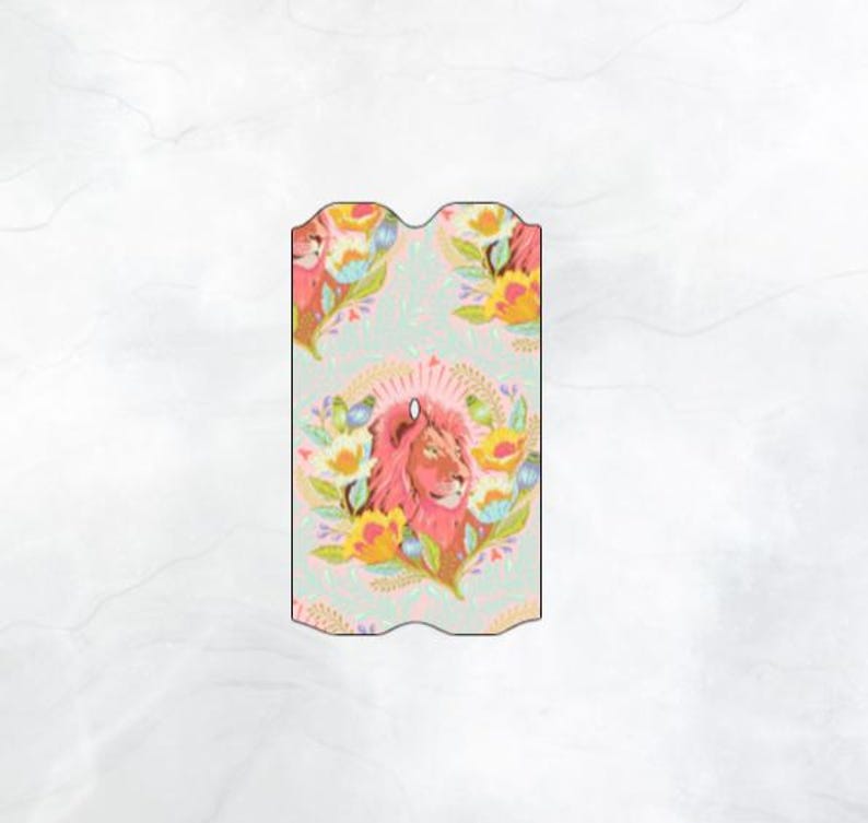 May include: A pink lion with a floral pattern on a light blue background. The lion is surrounded by flowers and leaves in shades of pink, yellow, and green.