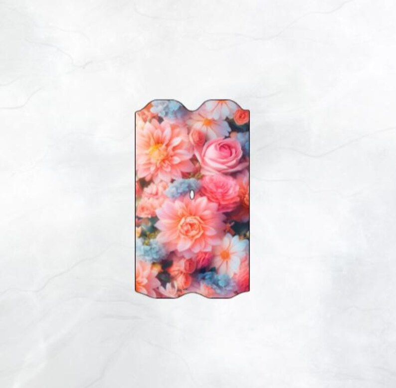 May include: A floral design featuring a variety of pink, peach, and blue flowers. The arrangement includes roses, dahlias, and other blossoms. The background is a light, neutral color.