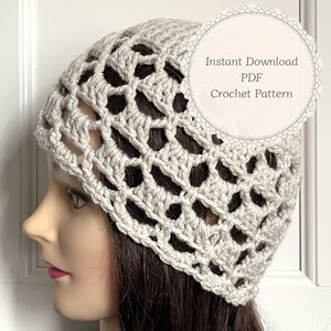 May include: A beige crochet beanie with an openwork lattice pattern. A circular white graphic overlay on the right side features the text: Instant Download PDF Crochet Pattern. The beanie is displayed on a mannequin head with dark hair.