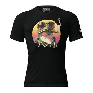 May include: Black t-shirt with a graphic of a frog wearing sunglasses and smoking a cigar. The frog is sitting in front of a sunset.