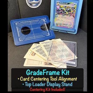 May include: A GradeFrame Kit featuring a blue card centering tool, a light blue top loader display stand holding an Umbreon EX trading card, and several instructional cards. The text reads GradeFrame Kit, Card Centering Tool Alignment, Top Loader Display Stand, and Centering Kit Included!