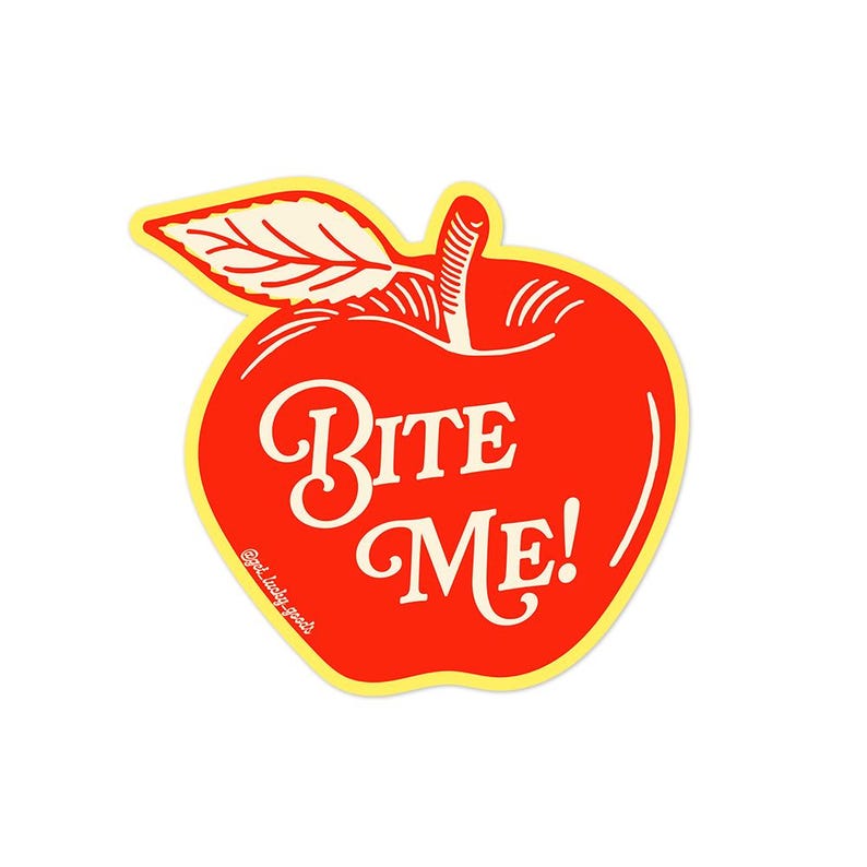 May include: A red apple-shaped sticker with a yellow border featuring a white leaf and stem at the top. The text BITE ME! is printed in white with a decorative serif font across the centre. The small text @get.lucky.goods is visible on the left.