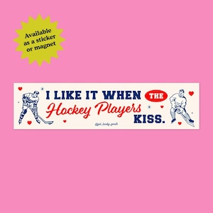 May include: A rectangular sticker or magnet featuring a cream background with blue and red text that reads I LIKE IT WHEN THE Hockey Players KISS. The design includes two illustrations of hockey players in blue uniforms and small red hearts.