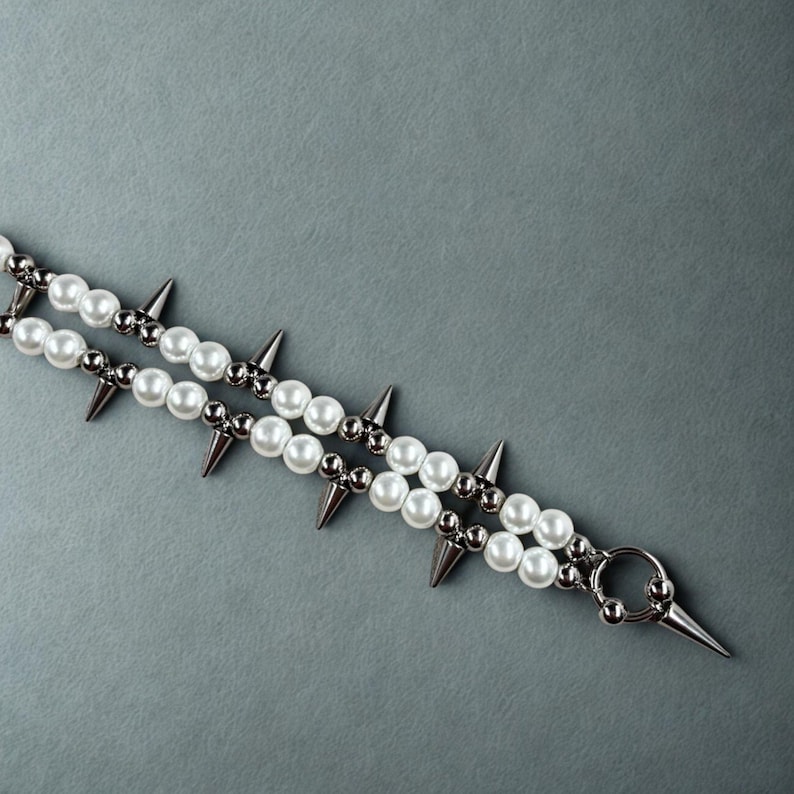 Close-up of pearl and spike necklace showing center ring pendant